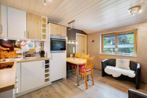 a kitchen and dining room with a table and chairs at Ferienwohnungen Talblick in Kirnbach