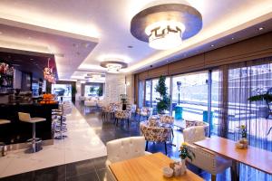 a restaurant with tables and chairs and a bar at Limak Ambassadore Hotel Ankara in Ankara