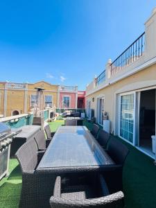 a patio with wicker chairs and a table at Paraiso en Palmmar in Palm-mar +16 photos