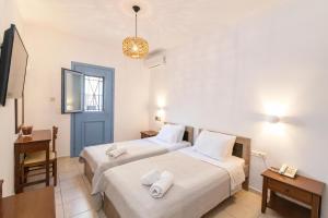 Postel nebo postele na pokoji v ubytování Agapi Hotel Tinos + 29 fotografií