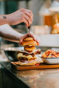a person making a sandwich with a knife and fork at 3 Buzzard Rest, Camp Tapnell in Yarmouth