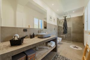 a bathroom with a sink and a toilet and a shower at Villa Elisa  +20 photos