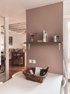 a basket sitting on top of a bed in a room at La Maison Gabriac in Boissise-la-Bertrand
