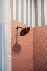 a shower with a shower head in a bathroom at Rhinestone Cowboy in East Nashville, 5 minutes to Downtown and Broadway in Nashville +31 photos