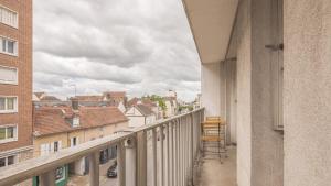 a balcony with chairs and a view of a city at Le Refuge 1 - Arboréa - Hypercentre - 4 pers in Troyes