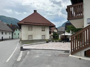 a building with a red roof on a street at APARTMA ALMA in Bovec