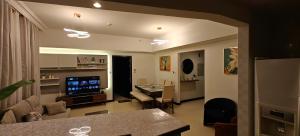 a living room with a television and a dining room at JLT 1BR Marina Skyline View in Dubai
