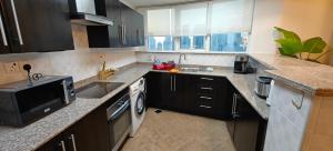 a kitchen with a sink and a stove top oven at JLT 1BR Marina Skyline View in Dubai