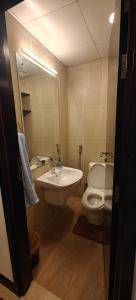 a bathroom with a sink and a toilet and a mirror at JLT 1BR Marina Skyline View in Dubai
