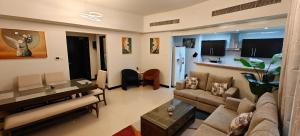 a living room with a couch and a table at JLT 1BR Marina Skyline View in Dubai