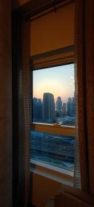 a window with a view of a city skyline at JLT 1BR Marina Skyline View in Dubai