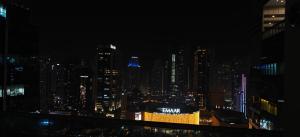 a view of a city skyline at night at JLT 1BR Marina Skyline View in Dubai