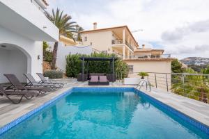 a villa with a swimming pool and a house at AVANOA - Sierra Altea in Alicante