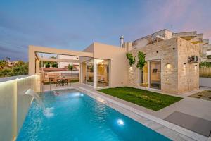 a house with a swimming pool in front of it at Avgi in Pitsidia