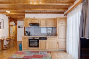 a kitchen with wooden cabinets and a stove at Auszeit in Donaueschingen