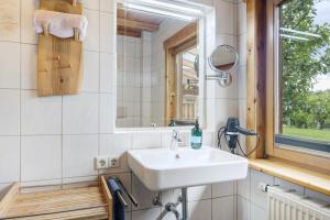 a bathroom with a sink and a mirror at Auszeit in Donaueschingen +17 photos