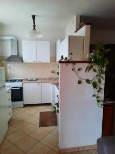 a kitchen with white cabinets and a counter top at Casa Gianfranco in Gubbio