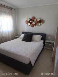 a bedroom with a large bed with plates on the wall at Pearl Apartments in Ofrínion