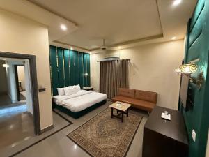 a hotel room with a bed and a couch at Shelton Accommodator in Peshawar