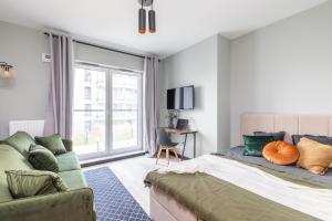 a bedroom with a bed and a couch at SuperApart Przy Forcie 12 in Warsaw