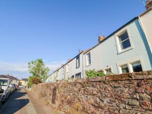 a row of houses behind a stone wall at Poets Retreat in Cockermouth