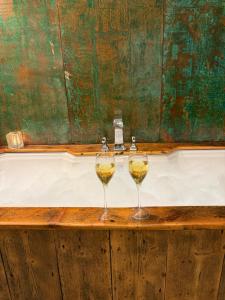 two glasses of wine sitting on a wooden table at Chocolate Box in Malvern Wells