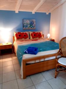 a bedroom with a bed with red flowers on it at Casa Marina Maltese via ucca marina SANTA MARIA DEL FOCALLO ISPICA in Santa Maria Del Focallo