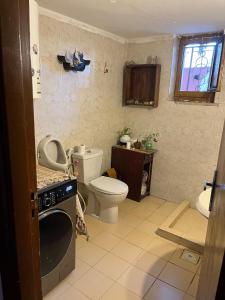 a small bathroom with a toilet and a sink at bayt alrahaal in Amman +31 photos