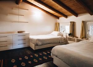 a bedroom with two beds and a dresser at Villa del '600 con giardino e piscina in Trento +51 photos