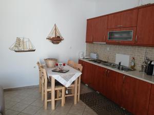 a small kitchen with a table and a sink at Artemis Bakery’s House 1 in Adamantas