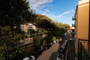 a view of a street with cars parked on the road at Ostia Bella Apartment in Lido di Ostia