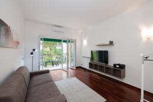 a living room with a couch and a television at Ostia Bella Apartment in Lido di Ostia