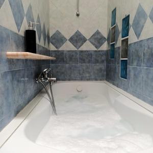 a bath tub with a water faucet in a bathroom at B&B Raggio di sole in Muggia
