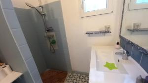 a bathroom with a sink and a shower at La cacarinette in Rayol-Canadel-sur-Mer +9 photos