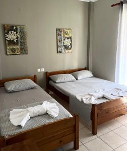 Postel nebo postele na pokoji v ubytování Nopi Rooms