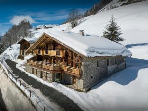 a log home in the snow with snow covered at Chalet Goville - OVO Network in La Giettaz