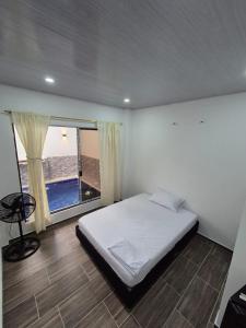 a bedroom with a bed and a large window at Casa de Char Girardot, Nariño Cundinamarca in Nariño +17 photos