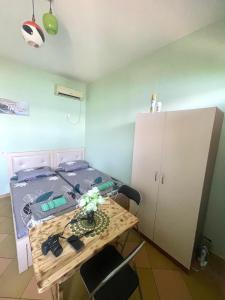 a small room with a table and a bed at Natyra te Eti in Shkodër +9 photos