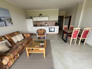 a living room with a couch and a table at Ferienwohnung Ostseeland 1 in Börgerende-Rethwisch