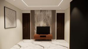 a television sitting on a wooden stand in a room at Hotel Airport View in Lucknow