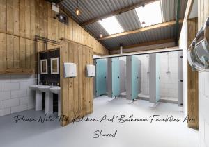 a bathroom with two sinks and toilets in a room at Container 5, Camp Tapnell in Yarmouth