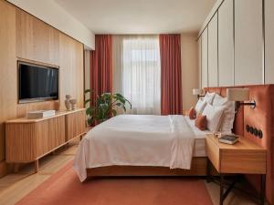 a hotel room with a bed and a television at The Julius Prague in Prague