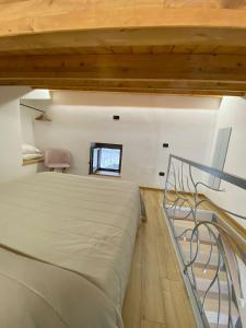 a bedroom with a large bed and a window at B&B vicoli della cattedrale in Melfi