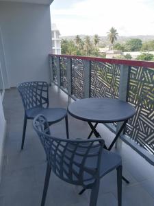 two tables and chairs on a balcony with a view at Sabrina Plaza Residence in Las Terrenas +92 photos