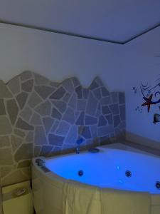 a bath tub in a bathroom with a blue light at Belvedere in Castro di Lecce +33 photos
