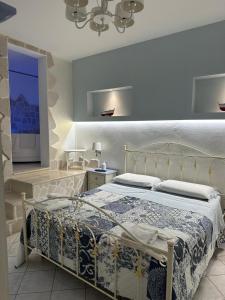 a bedroom with a bed and a television in it at Belvedere in Castro di Lecce