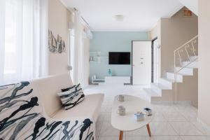 Una sala de estar con un sofá y una escalera. en F & B Summer Collection - Sithonia - Family Maisonette, en Ormos Panagias
