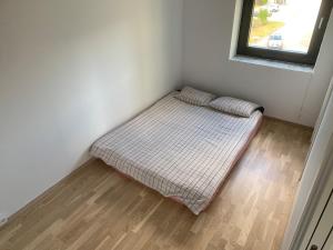 a bed in a corner of a room with a window at Peer Gynts vei 77 in Moss