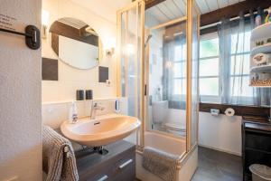 a bathroom with a sink and a shower at Fewo To Huus Pellworm in Pellworm +25 photos
