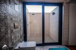 a bathroom with a shower with a toilet and a glass door at Twelve Tumbleweed, Cathkin Estates by Euphoric Leisure in Champagne Valley +13 photos